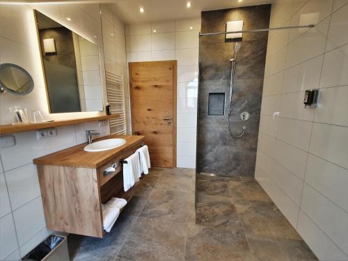 a bathroom with a sink and a shower at Der Obere Wirt zum Queri in Andechs