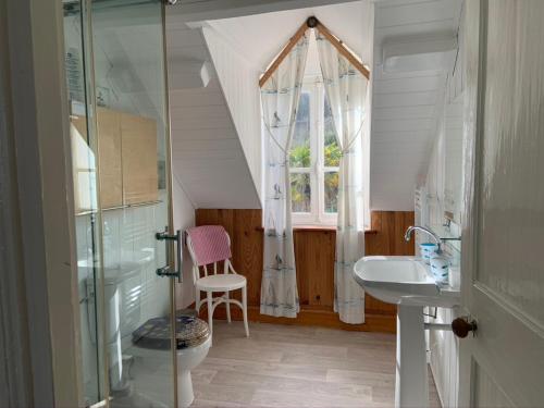 a bathroom with a sink and a window at St Guenole Apartments in Landévennec