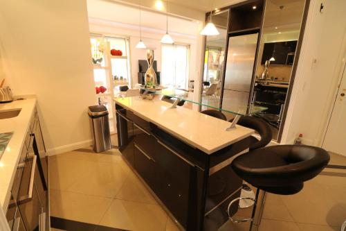 une cuisine avec un comptoir et un tabouret. dans l'établissement Beautiful 3 bedroom. Direct sea view. 401, à Cannes