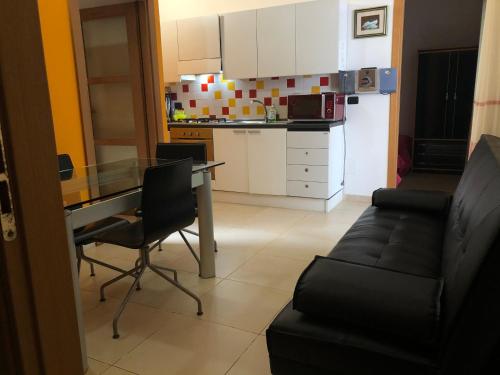 a kitchen and a living room with a table and a couch at Residence Sa Pintadera in Càbras