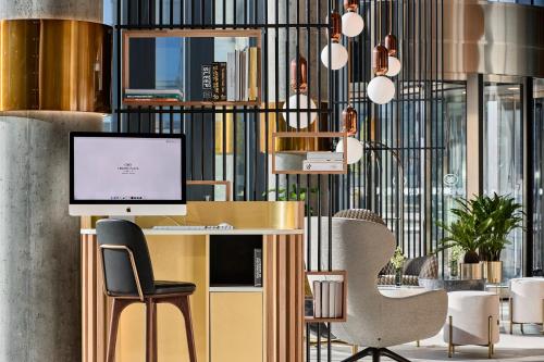 an office with a desk with a computer and chairs at Crowne Plaza - Warsaw - The HUB by IHG in Warsaw