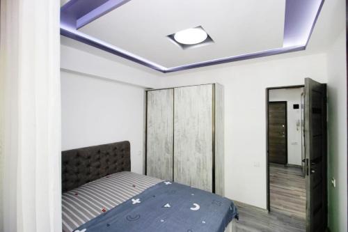 a bedroom with a bed and a mirror at Excellent apartment in the center of the Yerevan 15 in Yerevan