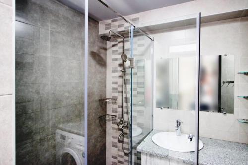 a bathroom with a sink and a glass shower at Excellent apartment in the center of the Yerevan 15 in Yerevan