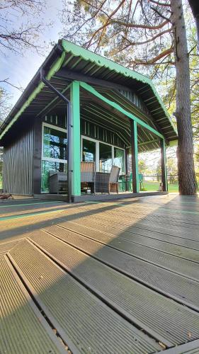 un pabellón con bancos en una terraza de madera en VIP Yellow dream house Sodyba Geras en Anykščiai