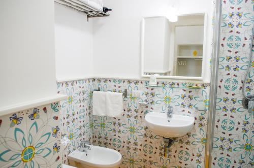 a bathroom with a sink and a mirror at Maison San Paolo in Sorrento