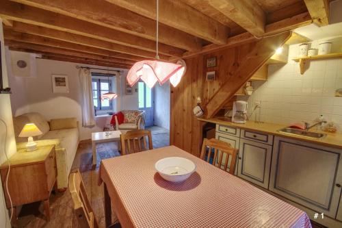 a kitchen with a table with a bowl on it at Les Trois Noyers in Tailhac
