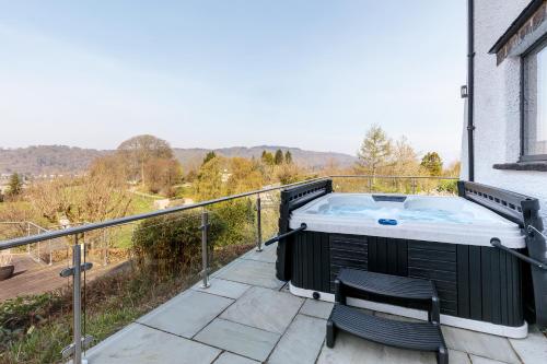 a hot tub on the balcony of a house at Cherry Trees in Windermere