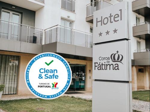 a hotel sign in front of a building at Hotel Coroa de Fátima in Fátima