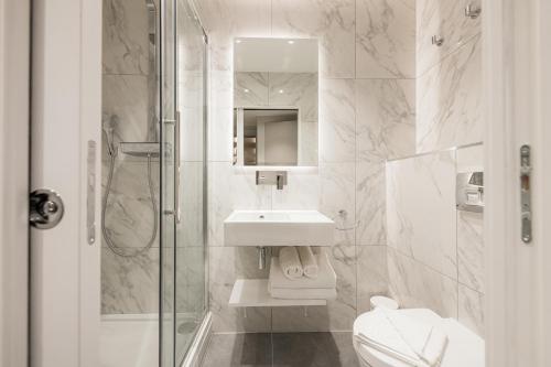 a white bathroom with a sink and a toilet at 198 Studios in London