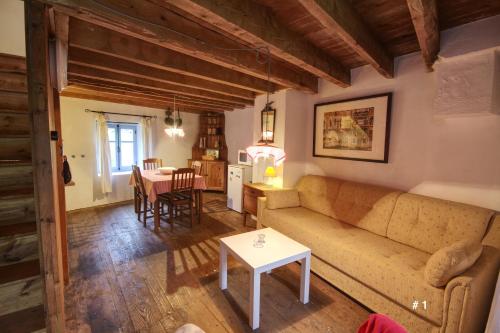 a living room with a couch and a table at Les Trois Noyers in Tailhac