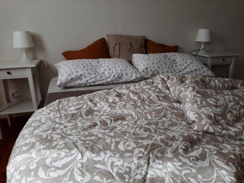 an unmade bed with two pillows on top of it at cà bianca in Latisana