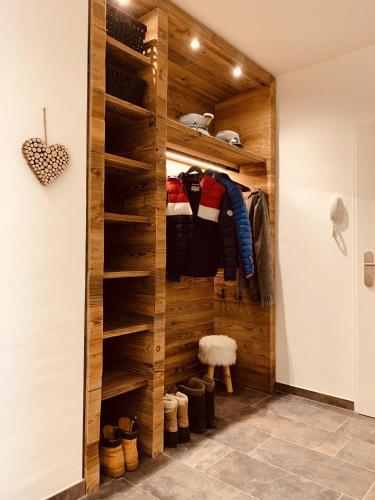 a walk in closet with wooden walls and shelves at Die Tauplitz Lodges - Penthouse Grimming D7-1 by AA Holiday Homes in Tauplitz