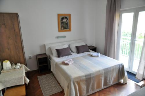 Postel nebo postele na pokoji v ubytování Rose rooms at island of Rab
