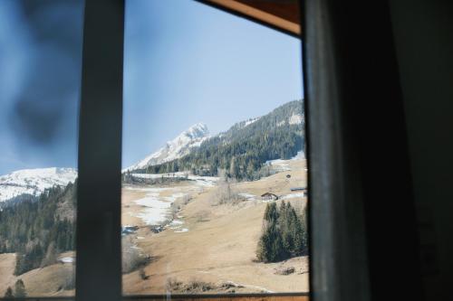 a view of a mountain from a window at Bergauf Appartement in Grossarl