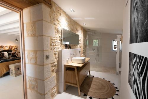 a bathroom with a sink and a shower in a room at Hors-série en Périgord in Millac