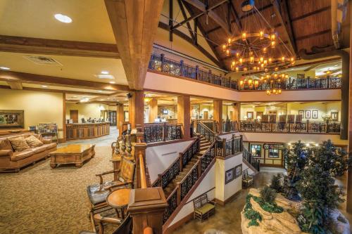 a large lobby with a staircase and a living room at Club Wyndham Glacier Canyon in Lake Delton