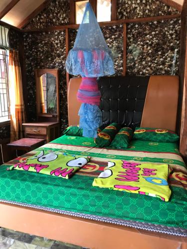a bed with a cake on top of it at Riverside Nature Bungalow - Namo Samsah Jungle Paradise in Bukit Lawang