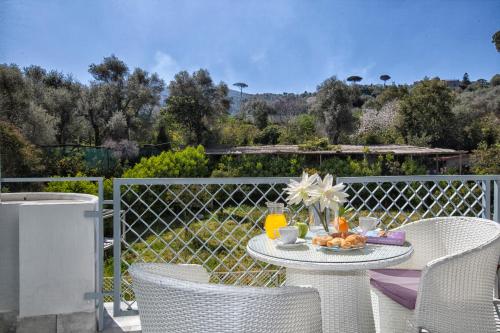 a table with a plate of food on a balcony at Atlantic Palace Hotel in Sorrento