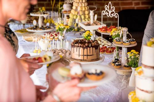 a table full of desserts and cakes on plates at SCHULZENS Brauerei & Hotel in Tangermünde