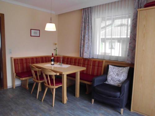 a living room with a table and a couch at Ferienwohnungen Rahm in Mayrhofen