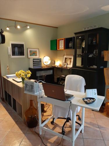 a kitchen with a desk and a laptop on a table at cà bianca in Latisana