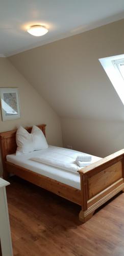 a bedroom with a bed in a attic at Airport Hotel One Aparthotel Sylt in Tinnum