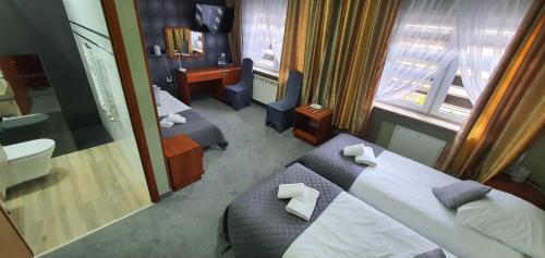 Katil atau katil-katil dalam bilik di Hotel Bursztynowy