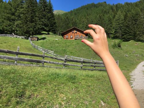 a person taking a picture of a barn at Ferienhof Oberer Gollmitzer in Heiligenblut
