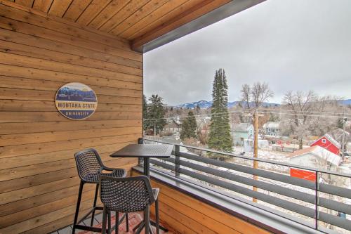 a balcony with a table and two chairs and a large window at Chic Bozeman Apartment - 1 Block Off West Main St! in Bozeman
