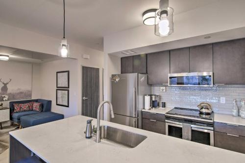 a kitchen with a sink and a refrigerator at Chic Bozeman Apartment - 1 Block Off West Main St! in Bozeman