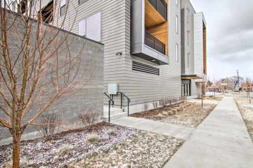a building with a fence next to a sidewalk at Chic Bozeman Apartment - 1 Block Off West Main St! in Bozeman