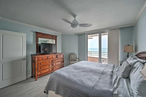 a bedroom with a bed and a television and a window at Oceanfront Marco Island Escape with Beach Access! in Marco Island