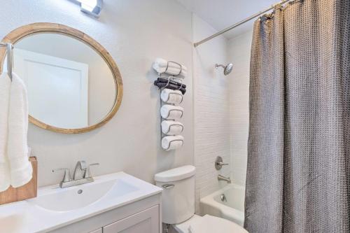 a bathroom with a sink and a toilet and a mirror at Updated Fayetteville Home Less Than 2 Miles to UArk! in Fayetteville