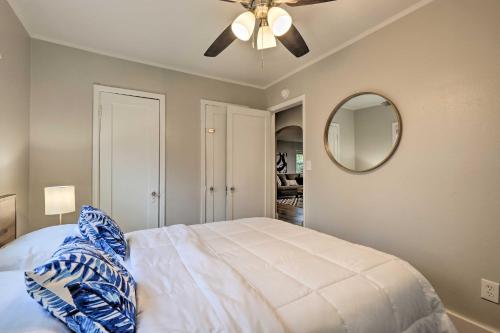 a bedroom with a bed with a ceiling fan and a mirror at Updated Fayetteville Home Less Than 2 Miles to UArk! in Fayetteville