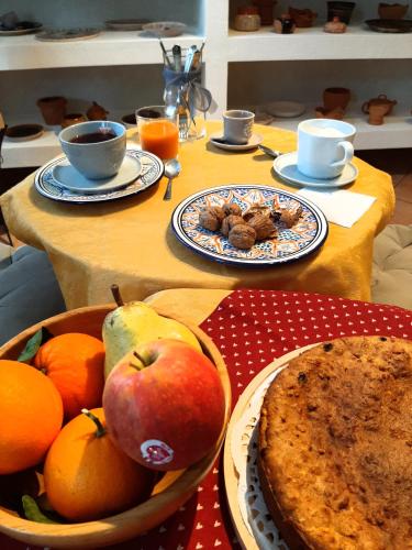 a table with fruit and bread and plates of food at cà bianca in Latisana