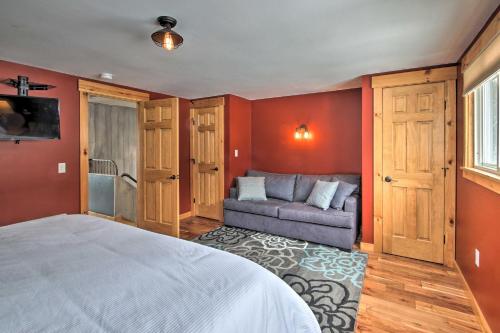 a bedroom with a bed and a couch in it at Ski-InandOut Burke Mtn Condo with Amenity Access! in East Burke