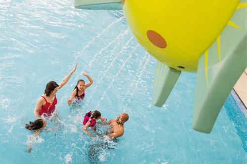 a group of people in the water at a water park at Haven Haggerston castle caravan hire in Cheswick