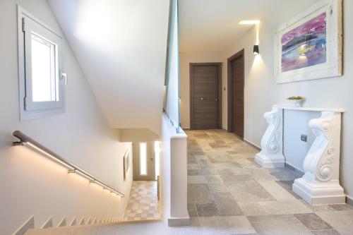 a staircase in a house with a stair case at Sunrise Bay Apts in Ayia Evfimia