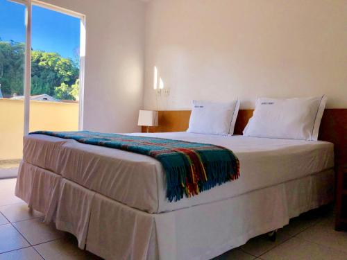 Cama ou camas em um quarto em Dom Pedro Hotel