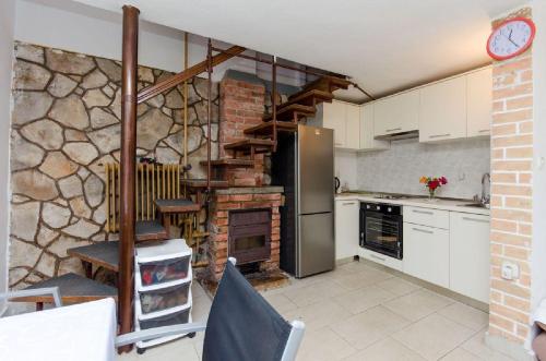 a kitchen with a stone wall at House Renato in Ivan Dolac
