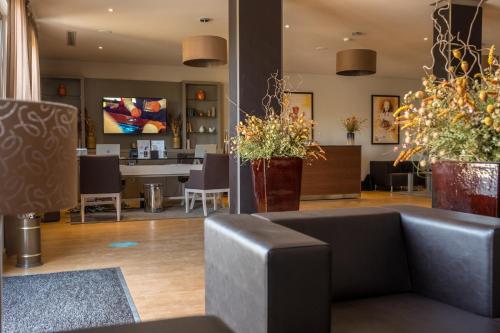 a lobby with a couch and chairs and a table at Vila Gale Douro Vineyards in Armamar