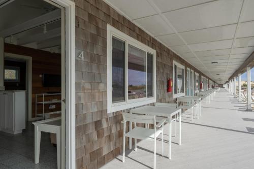 a row of tables and chairs on a building at Driftwood Resort on the Ocean in Montauk