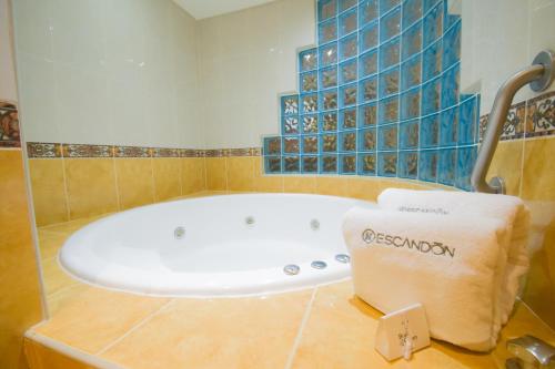 a bath tub in a bathroom with a towel at KALI Escandón Mexico City in Mexico City