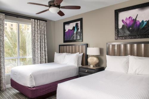a bedroom with two beds and a ceiling fan at Club Wyndham Grand Desert in Las Vegas