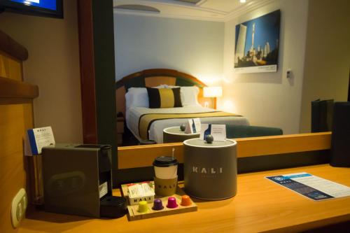 a hotel room with a bed and a desk at KALI Escandón Mexico City in Mexico City