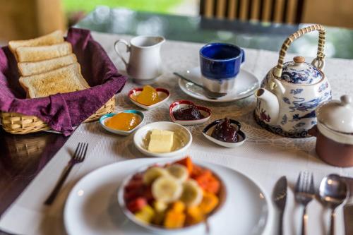a table with a plate of food on a table at Sat Nam Village Hotel in Sigiriya