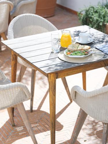 a wooden table with a plate of food on it at ADC - Albergaria Do Calvário - by Unlock Hotels in Évora