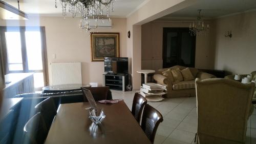 a living room with a table and a couch at EvgatisBeach Loyskoy 1 in Thános