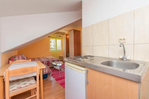 a kitchen with a sink and a living room at Apartments Kujacic in Herceg-Novi