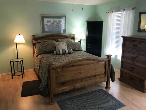 1 dormitorio con cama de madera y almohadas en Lakeside Condo on Lake Taneycomo en Branson